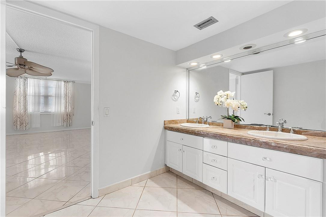 6100 Northwest 2nd Avenue, Unit 321 Boca Raton, FL 33487 - Photo 20 of 27 a bathroom with a double vanity sink and a mirror