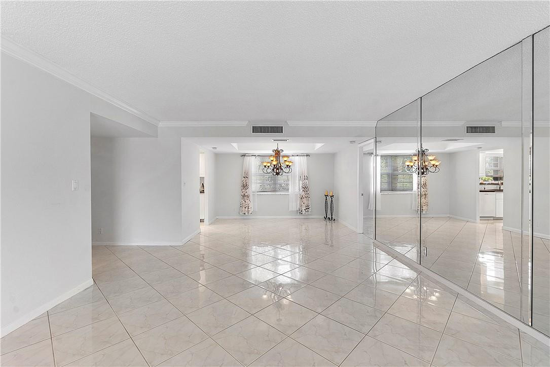 6100 Northwest 2nd Avenue, Unit 321 Boca Raton, FL 33487 - Photo 6 of 27 a view of a hallway with a chandelier