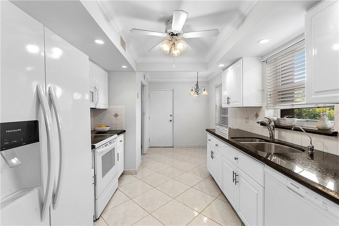 6100 Northwest 2nd Avenue, Unit 321 Boca Raton, FL 33487 - Photo 8 of 27 a large kitchen with granite countertop a sink a stove a refrigerator and cabinets