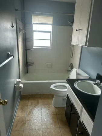 a bathroom with a toilet a sink and bathtub
