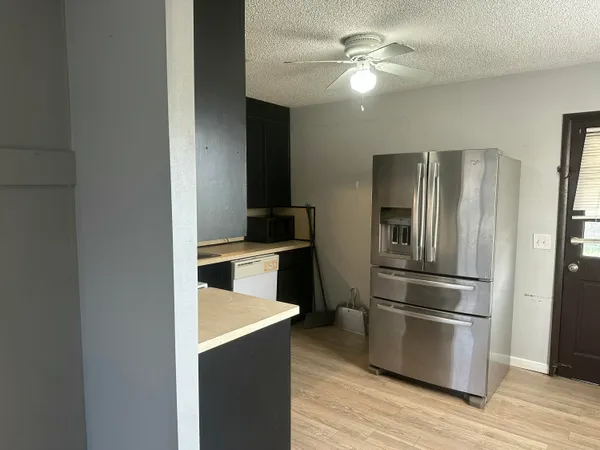 a kitchen with cabinets and stainless steel appliances