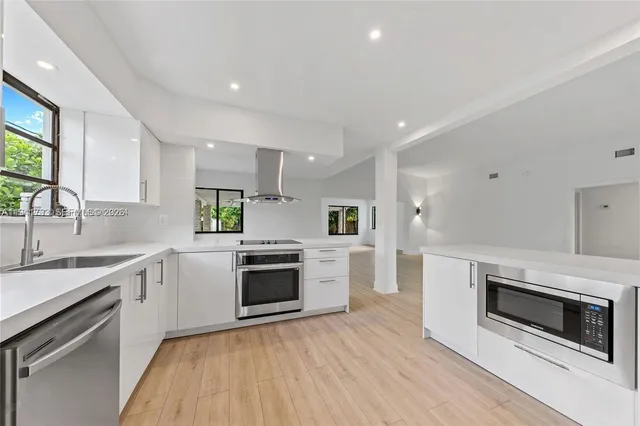 a kitchen with a stove a sink and a microwave