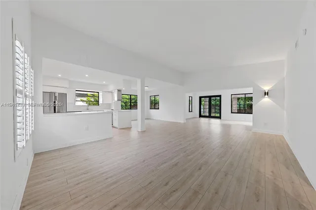 a view of a livingroom with wooden floor and furniture