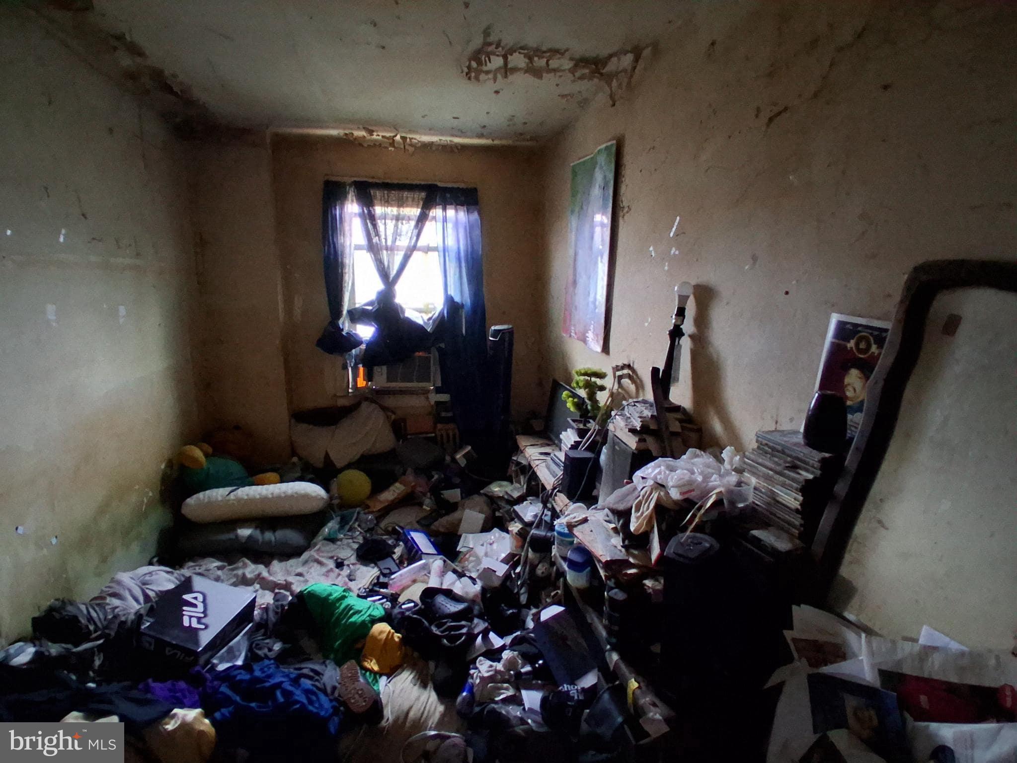 4035 Cedardale Road Baltimore, MD 21215 - Photo 18 of 40 a room with lots of flowers and lots of frames on the wall