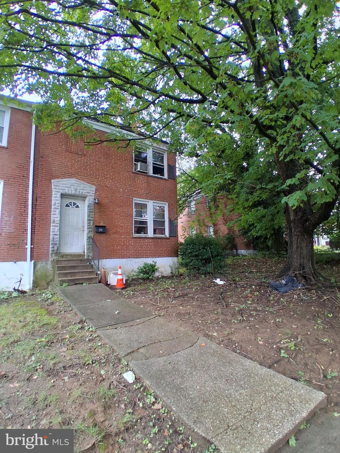 4035 Cedardale Road Baltimore, MD 21215 - Photo 2 of 40 a front view of a house with a tree