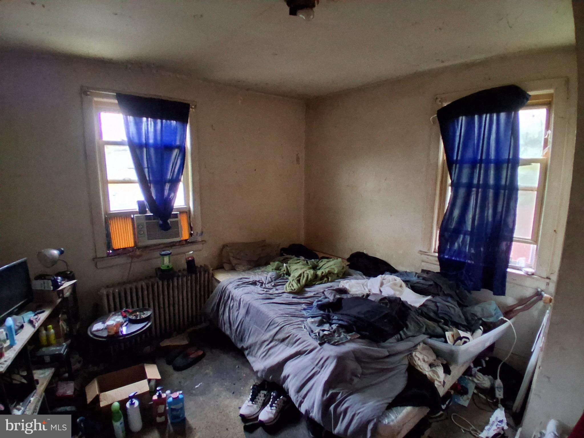 4035 Cedardale Road Baltimore, MD 21215 - Photo 21 of 40 a bed sitting in a bedroom next to a window
