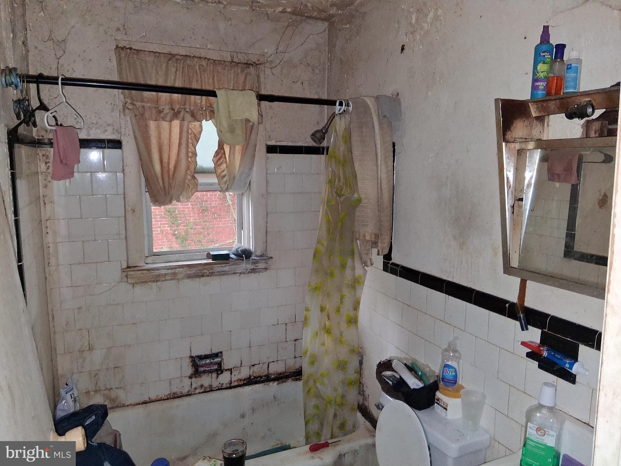 4035 Cedardale Road Baltimore, MD 21215 - Photo 26 of 40 a bathroom with a shower and a mirror