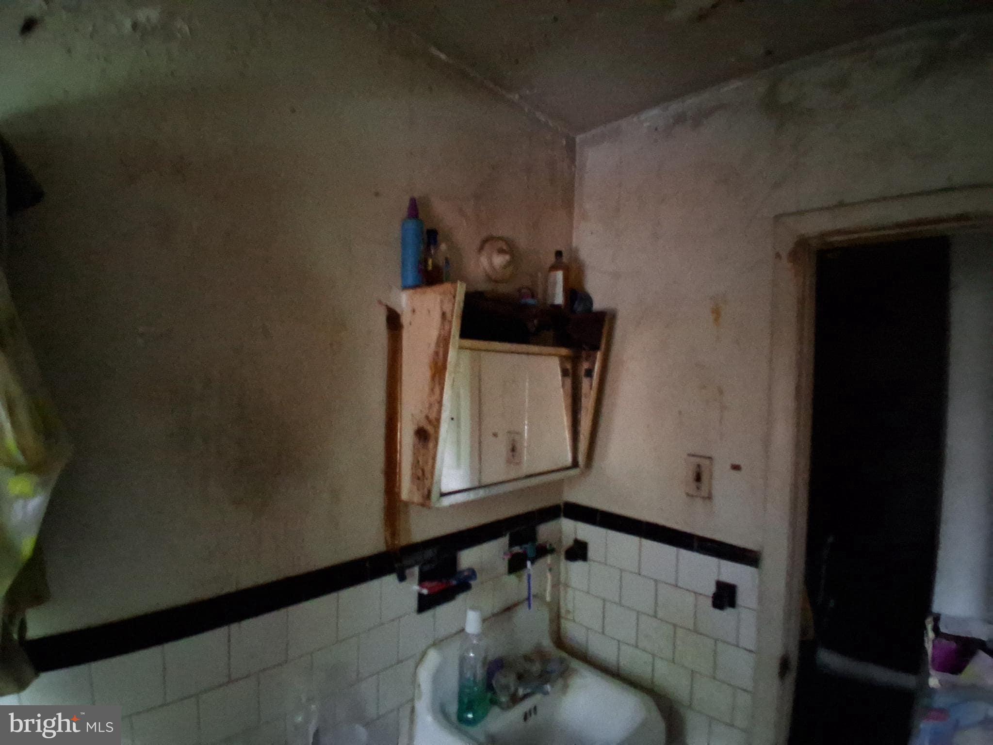 4035 Cedardale Road Baltimore, MD 21215 - Photo 28 of 40 a bathroom with a sink and a mirror