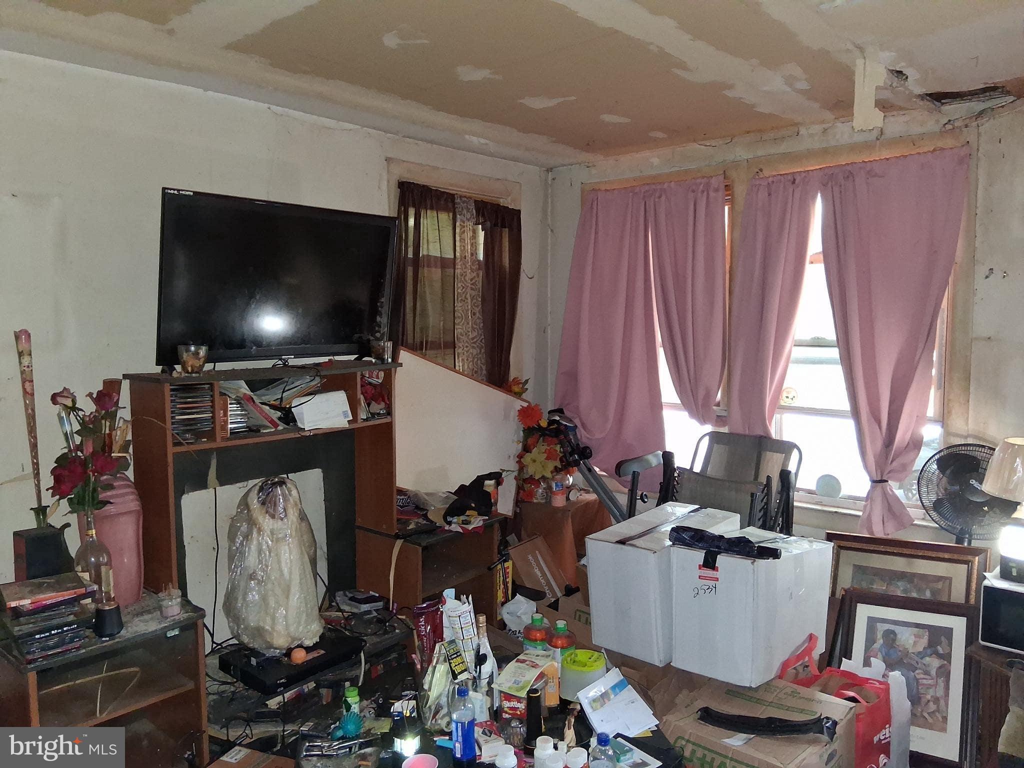 4035 Cedardale Road Baltimore, MD 21215 - Photo 4 of 40 a room with a flat screen tv and a window