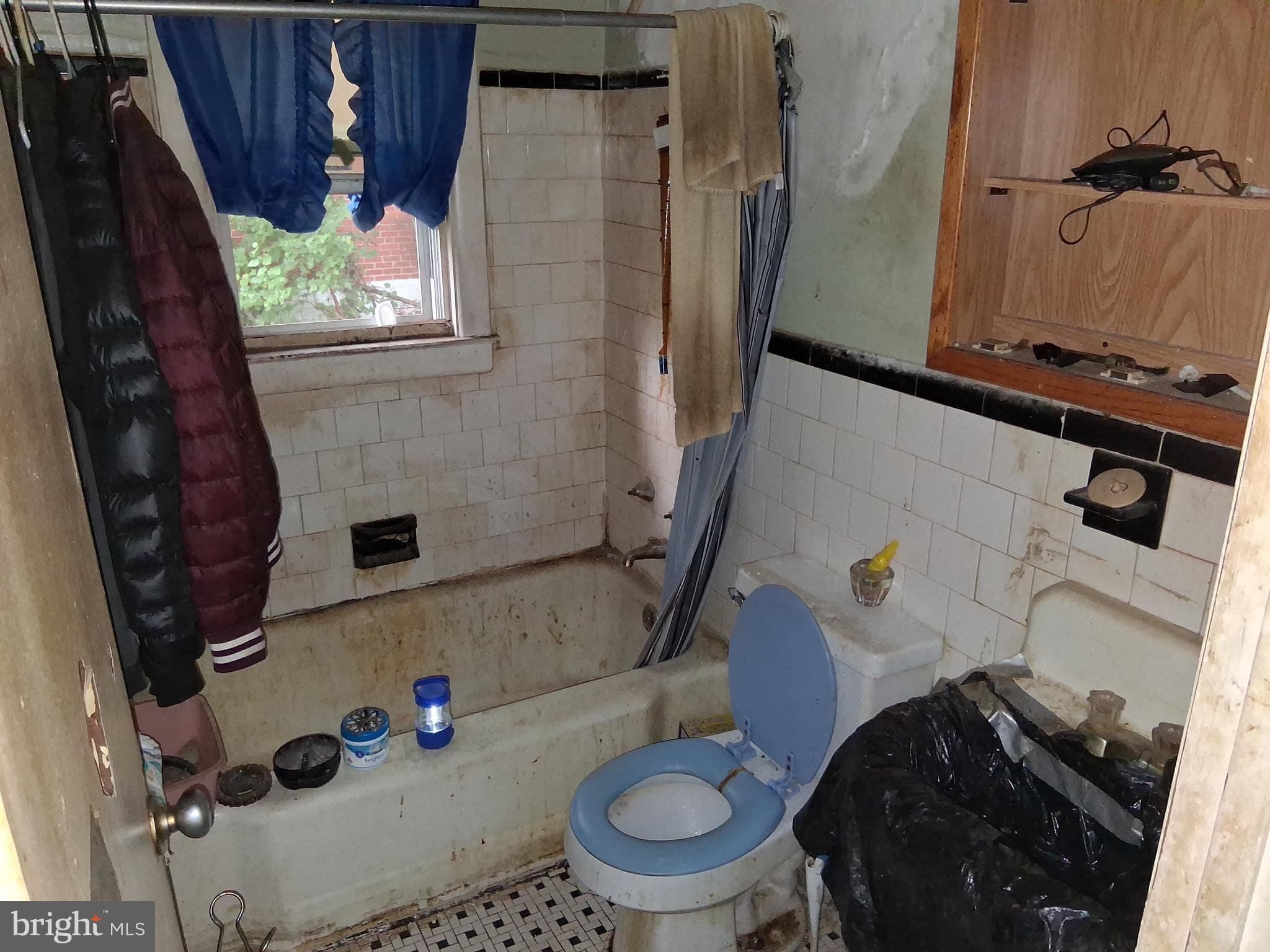 4035 Cedardale Road Baltimore, MD 21215 - Photo 10 of 40 a bathroom with a toilet and a shower