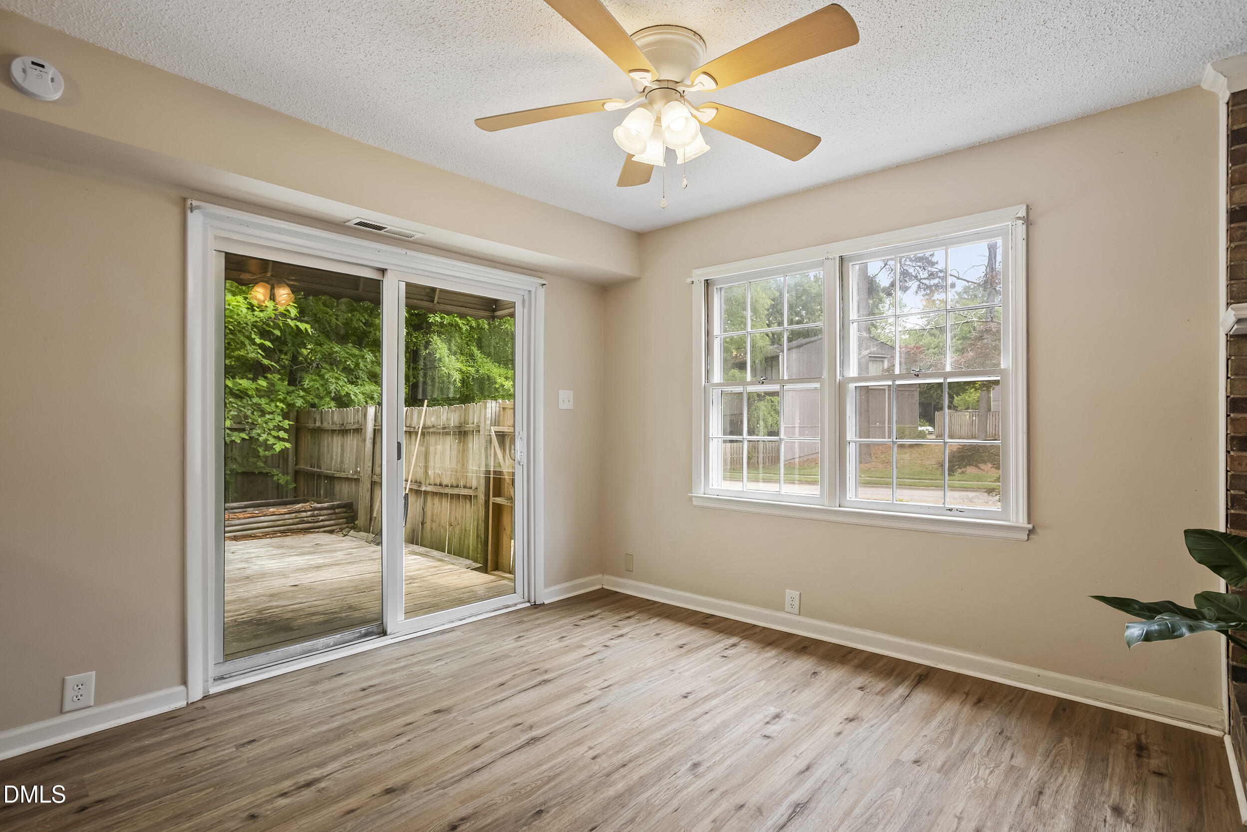 1801 Quail Ridge Road Raleigh, NC 27609 - Photo 12 of 29 a view of an empty room with wooden floor and a window