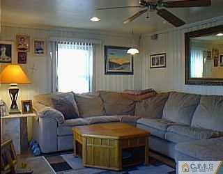 10 Fox Road Edison, NJ 08817 - Photo 1 of 8 a living room with furniture and a flat screen tv