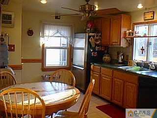 10 Fox Road Edison, NJ 08817 - Photo 2 of 8 a kitchen with stainless steel appliances granite countertop a refrigerator a sink a stove and island