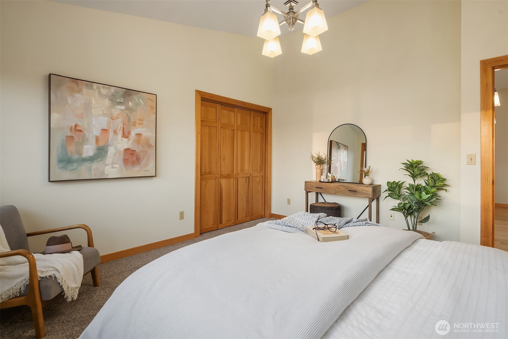 1002 Chuckanut Drive Bellingham, WA 98229 - Photo 19 of 40 a bedroom with a bed and a chandelier