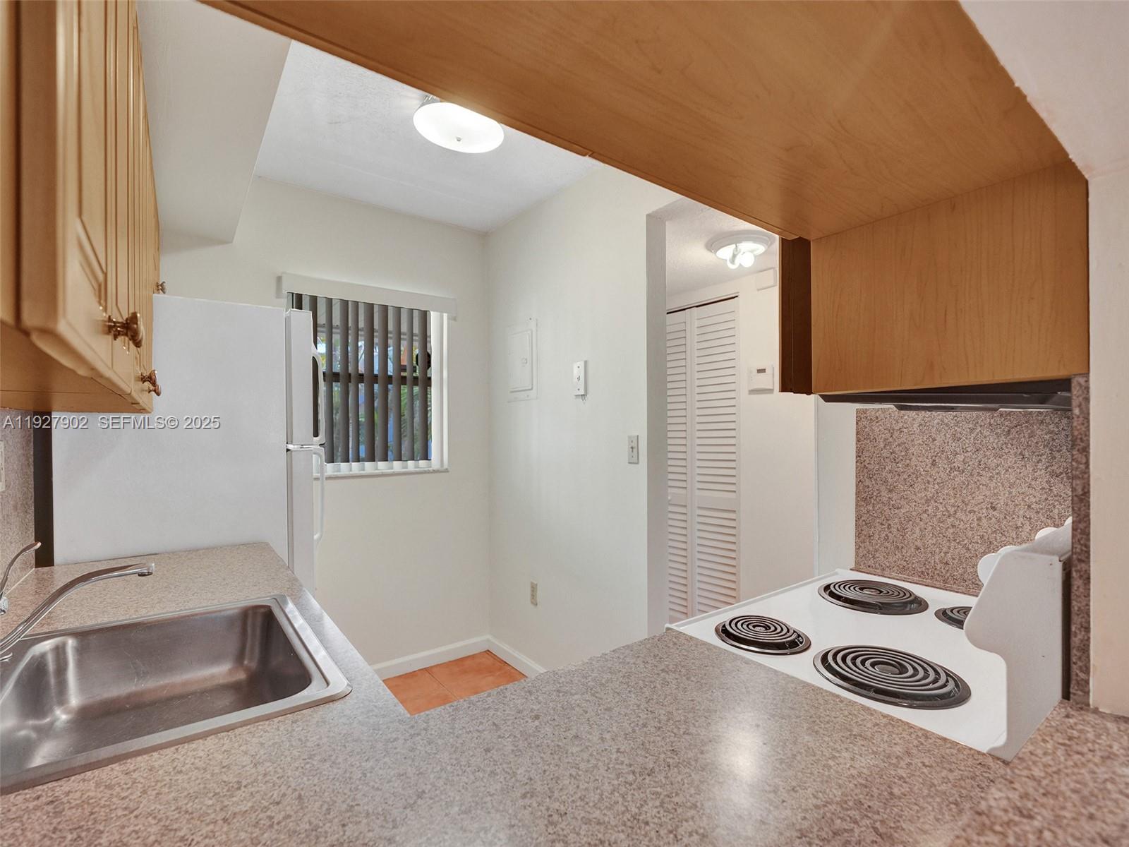 4600 Southwest 67th Avenue, Unit 235 Miami, FL 33155 - Photo 11 of 40 a bathroom with a sink and a washing machine
