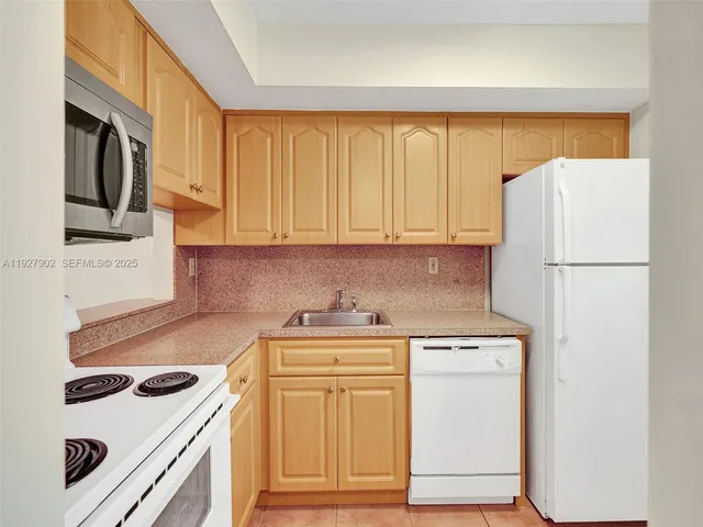 a kitchen with a white cabinets and white appliances