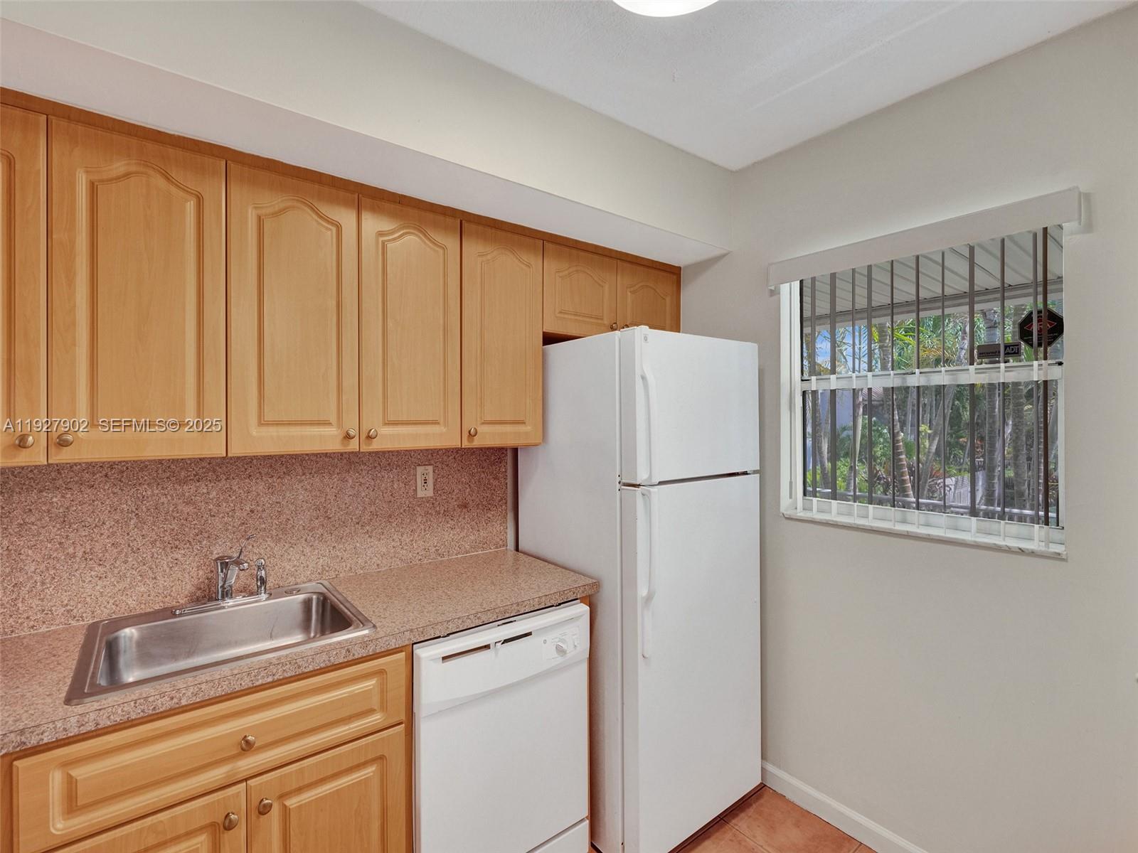 4600 Southwest 67th Avenue, Unit 235 Miami, FL 33155 - Photo 14 of 40 a white refrigerator freezer sitting in a kitchen