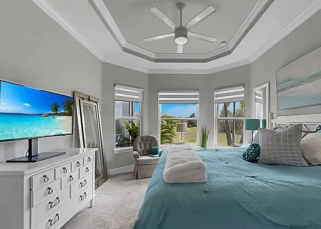 a living room with furniture and a floor to ceiling window