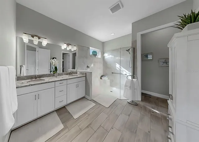 a kitchen with granite countertop a stove top oven cabinets and a refrigerator