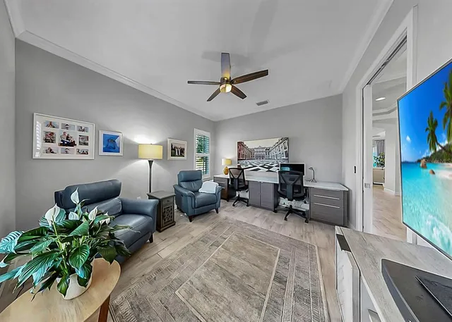 a kitchen with a center island wooden floor stainless steel appliances and windows