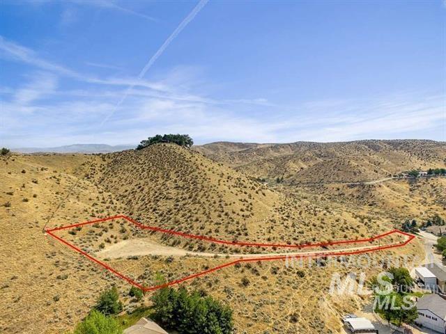 5912 West Hill Road Boise, ID 83703 - Photo 11 of 12 Aerial view of sparsely populated area with property boundaries highlighted and a mountain backdrop