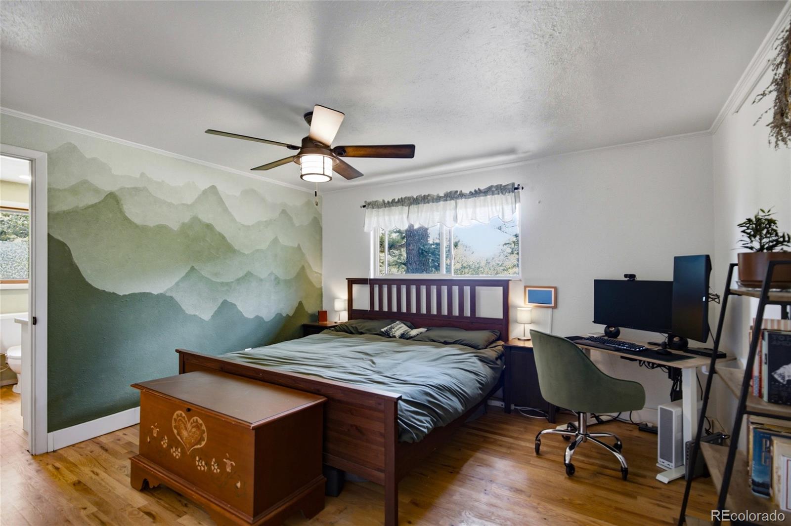 31280 Florence Road Conifer, CO 80433 - Photo 18 of 48 a bedroom with a bed window and a desk