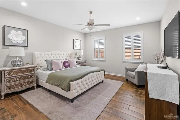 a view of a hallway with wooden floor and entryway