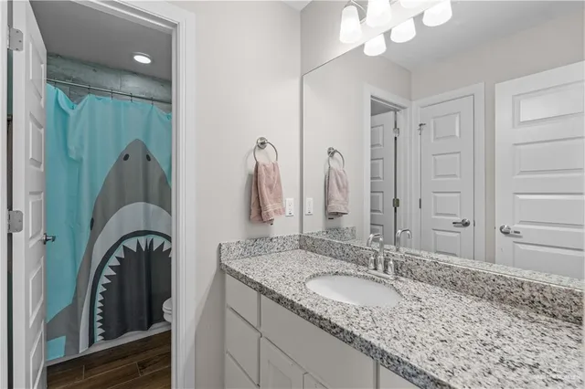 a large bed sitting in a bedroom next to a window