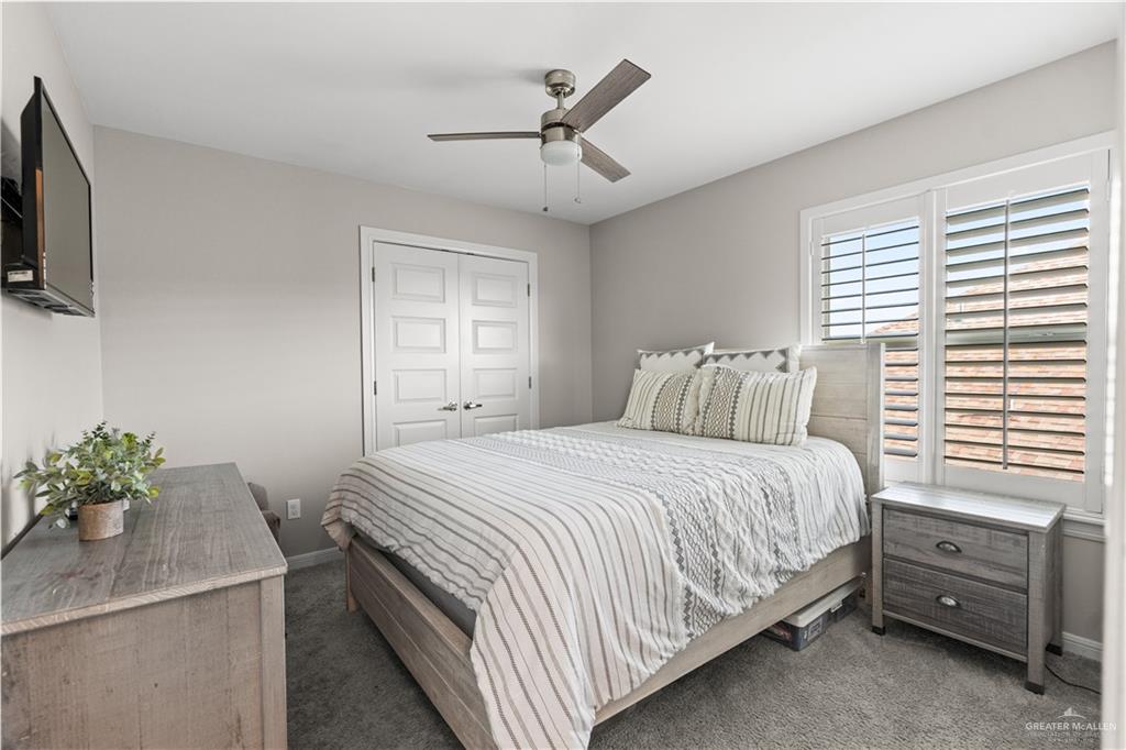 5508 River Road McAllen, TX 78504 - Photo 16 of 21 Bedroom featuring dark colored carpet, ceiling fan, and a closet