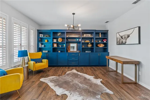 a bedroom with furniture and a book shelf
