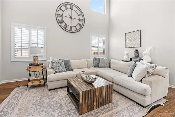 a living room with furniture a window and a clock