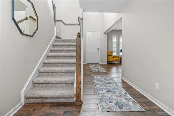 a dining room with a window and wooden floor