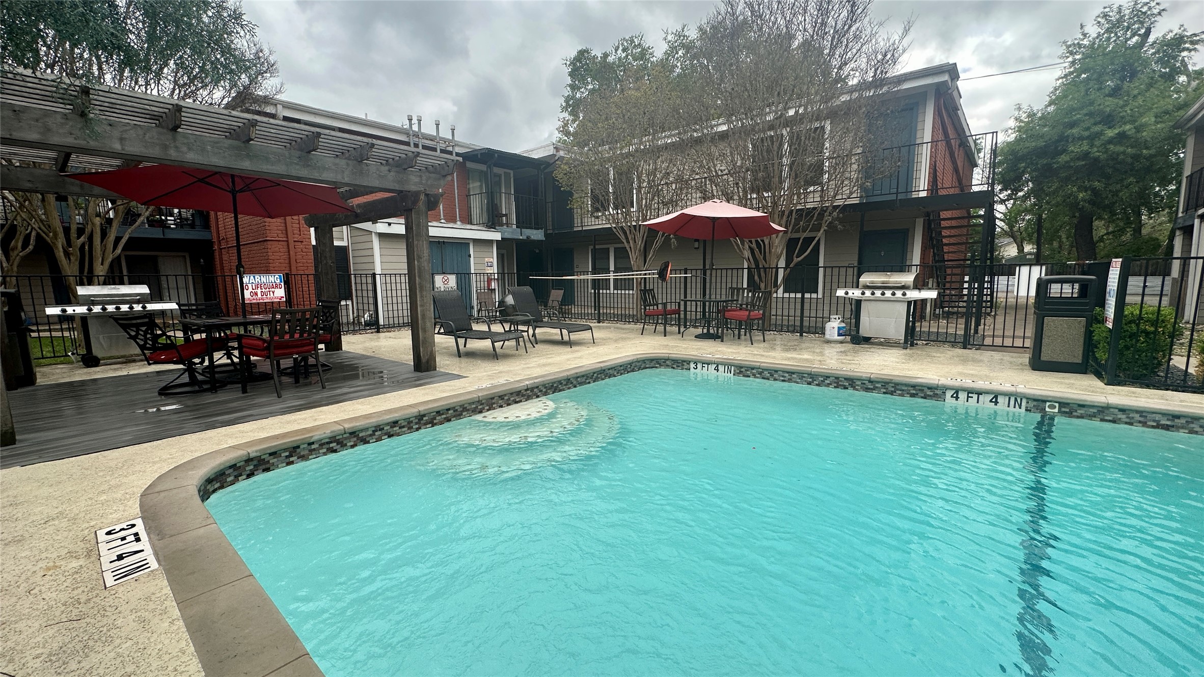 5426 Menchaca Road, Unit 109 Austin, TX 78745 - Photo 10 of 11 Community pool with a patio area, area for grilling, a wooden deck, and outdoor dining area