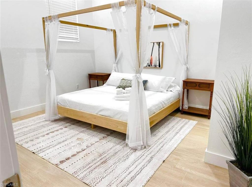 2881 Santa Barbara Boulevard Naples, FL 34116 - Photo 8 of 15 Bedroom featuring baseboards and wood finished floors