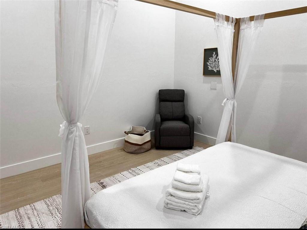 2881 Santa Barbara Boulevard Naples, FL 34116 - Photo 9 of 15 Bedroom featuring wood finished floors and baseboards