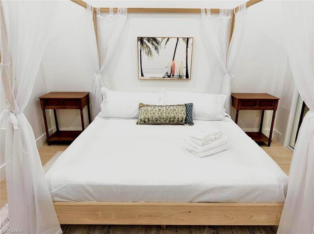 2881 Santa Barbara Boulevard Naples, FL 34116 - Photo 10 of 15 Bedroom with wood finished floors and baseboards