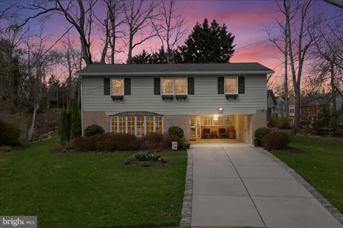 a front view of a house with a garden and pathway