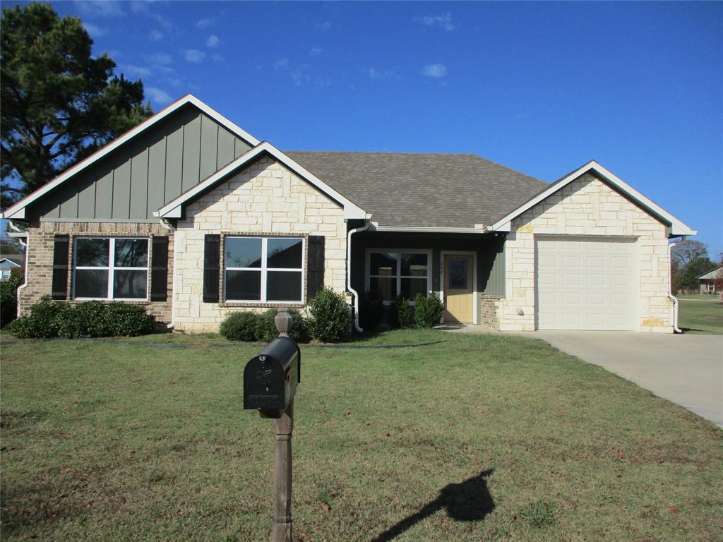 a front view of a house with yard outdoor seating and green space