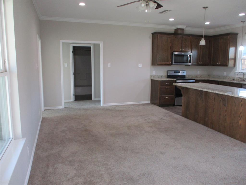 207 Mill Street Emory, TX 75440 - Photo 12 of 34 a large kitchen with stainless steel appliances granite countertop a refrigerator a stove top oven a sink and dishwasher