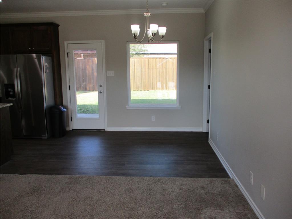 207 Mill Street Emory, TX 75440 - Photo 13 of 34 wooden floor in an empty room with a window