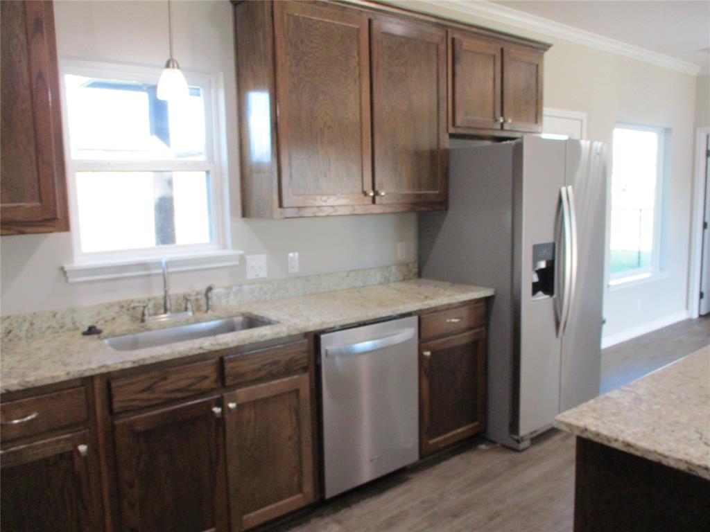 207 Mill Street Emory, TX 75440 - Photo 16 of 34 a kitchen with a sink a refrigerator and window