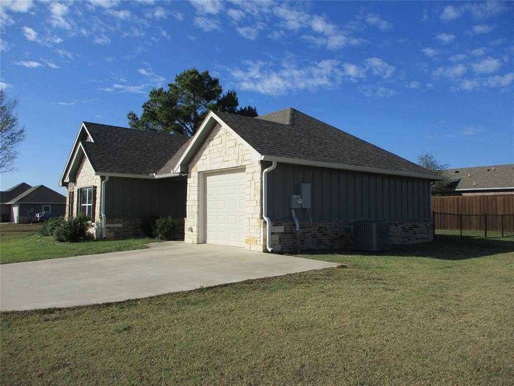 207 Mill Street Emory, TX 75440 - Photo 2 of 34 a front view of a house with a yard