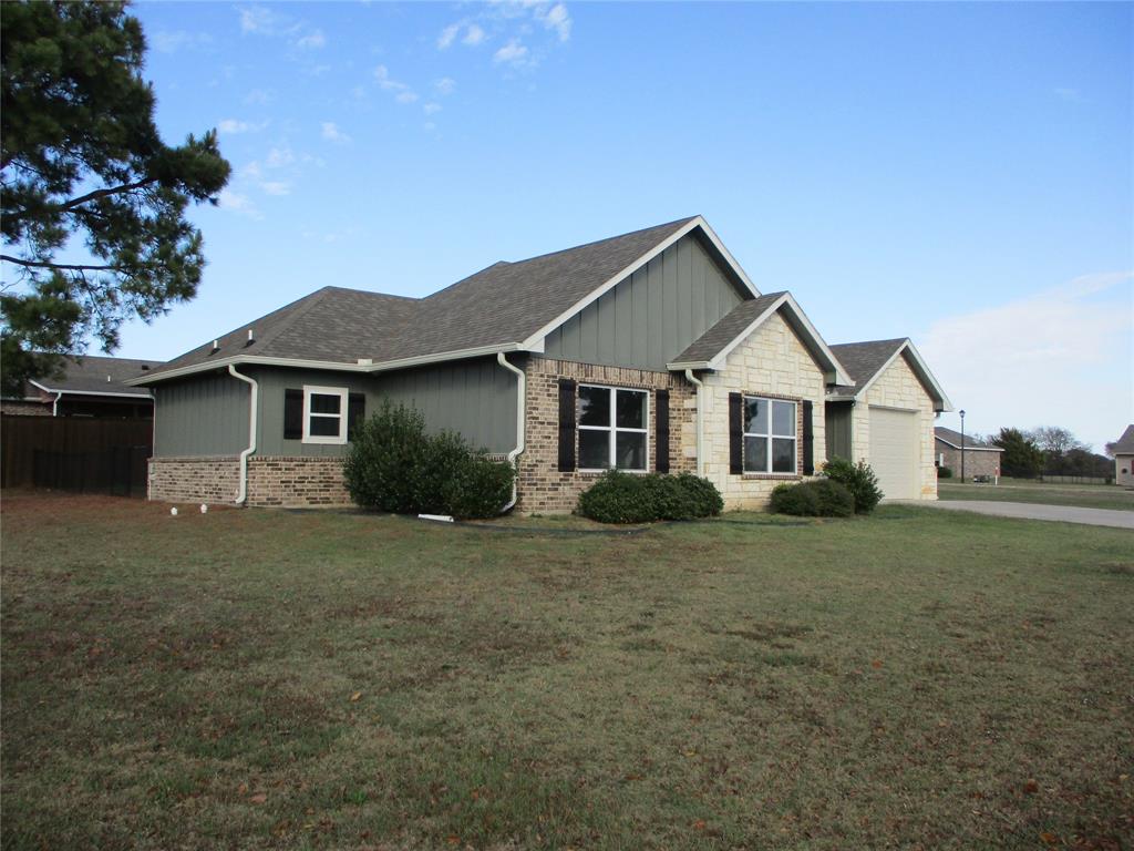 207 Mill Street Emory, TX 75440 - Photo 34 of 34 a front view of a house with a garden