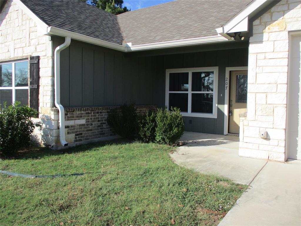 207 Mill Street Emory, TX 75440 - Photo 7 of 34 a front view of a house with garden