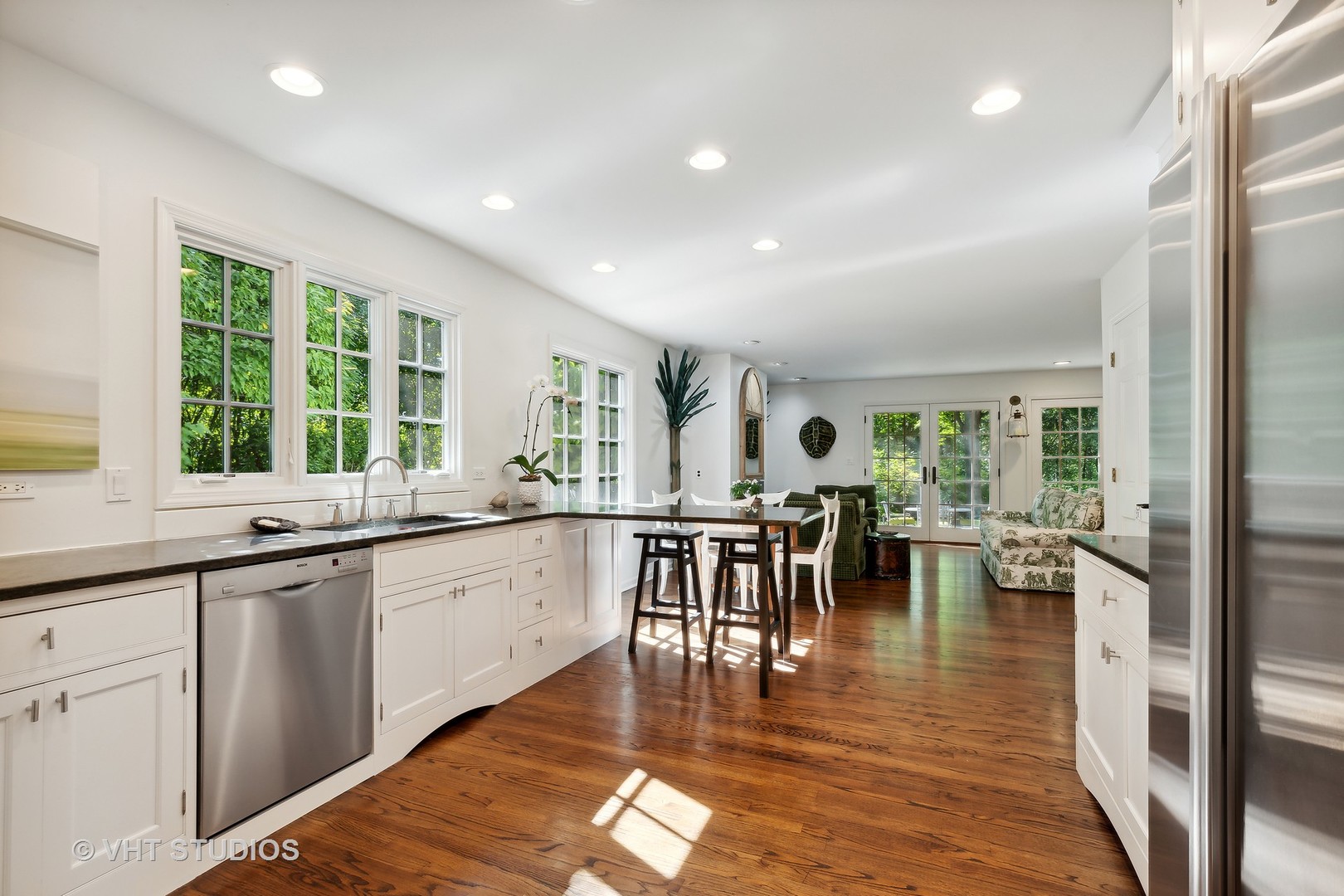 540 Buena Road Lake Forest, IL 60045 - Photo 23 of 37 a large dining hall with stainless steel appliances granite countertop a stove a sink a dining table and chairs with wooden floor