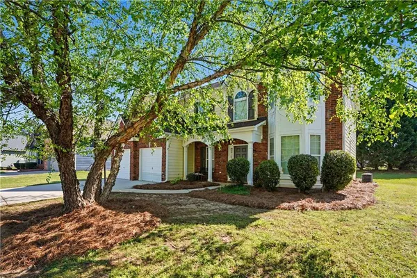 a front view of a house with a yard