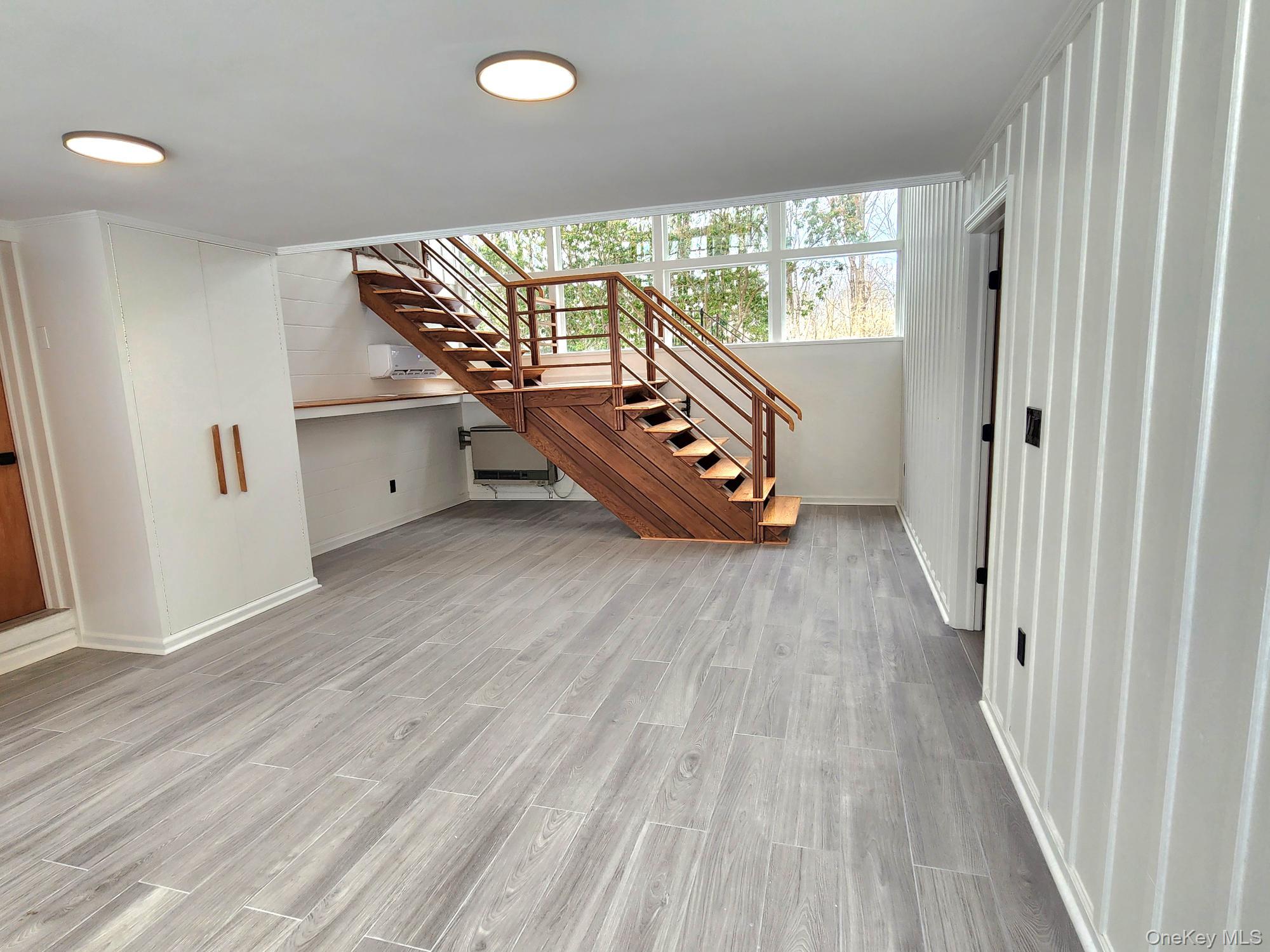 568 River Road Rhinebeck, NY 12572 - Photo 11 of 26 Unfurnished living room with stairs and light wood finished floors