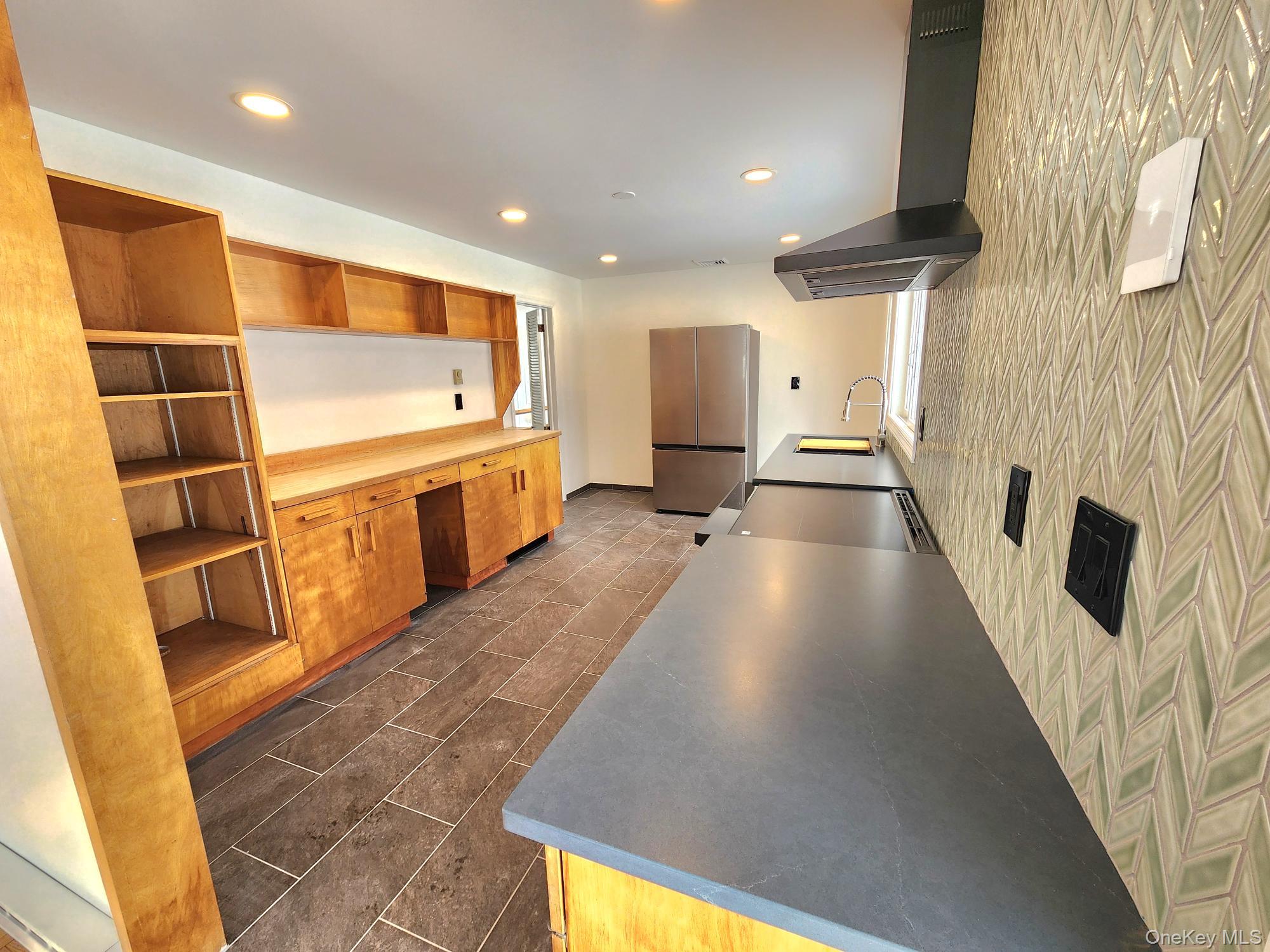 568 River Road Rhinebeck, NY 12572 - Photo 6 of 26 Kitchen featuring wall chimney range hood, stainless steel appliances, built in desk, open shelves, and recessed lighting