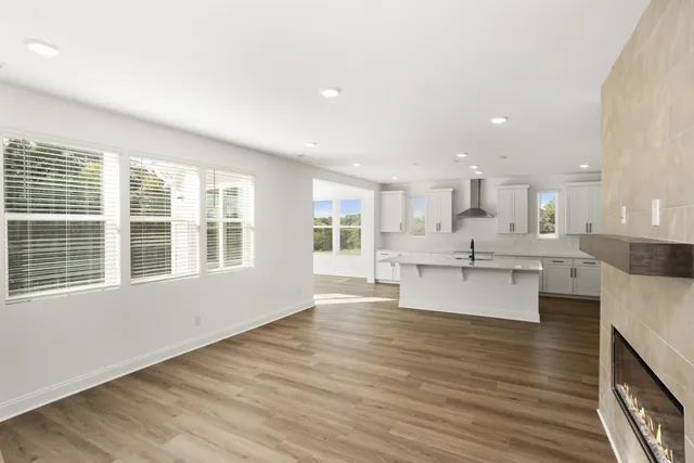 a large kitchen with kitchen island a sink a stove a center island and stainless steel appliances