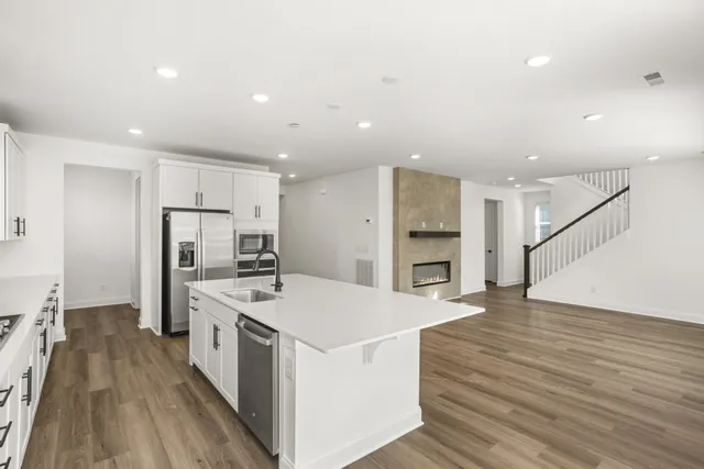 a large white kitchen with a large window